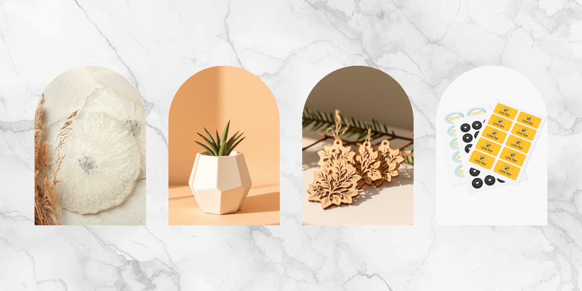 Handmade resin coasters, a 3D printed planter, laser cut ornaments and vinyl sticker sheets on grey marble